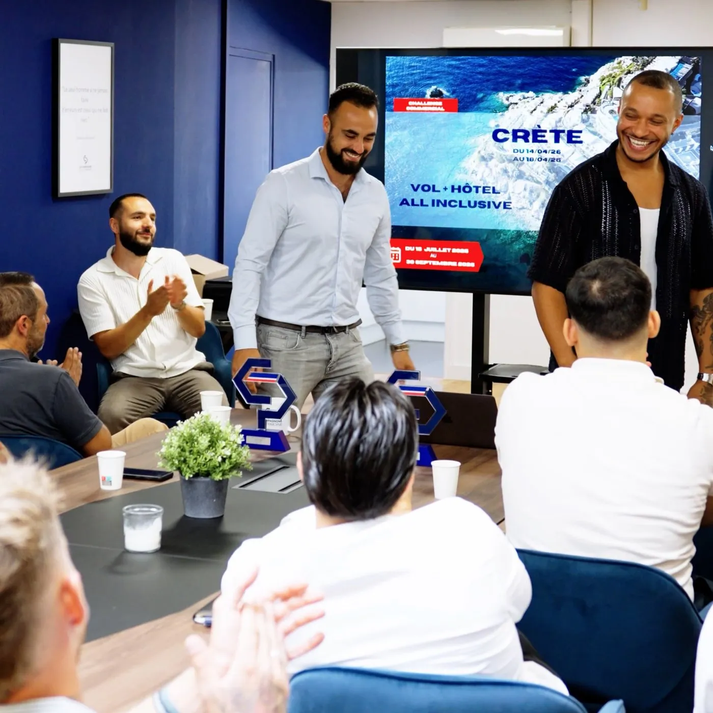 Les Compagnons du Patrimoine team meeting, with employees applauding the winners of a challenge