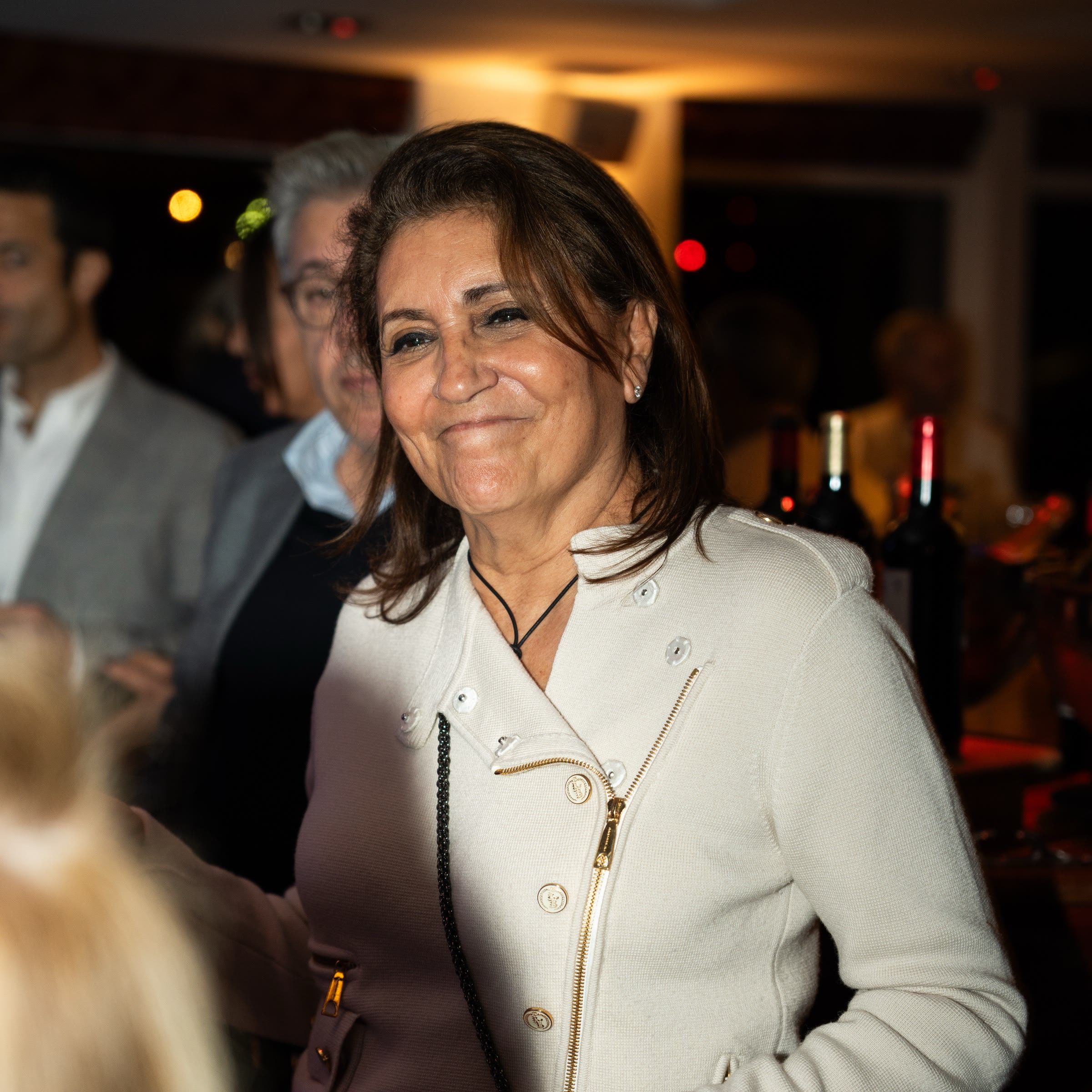 Une invitée en veste blanche, tout sourire